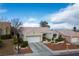 Inviting single-story home showcasing a two-car garage, desert landscaping, and a serene neighborhood setting at 10320 Bent Brook Pl, Las Vegas, NV 89134