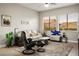 Comfortable living room with neutral walls, ceiling fan, and plenty of natural light at 10320 Bent Brook Pl, Las Vegas, NV 89134