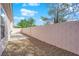 Private fenced backyard with rock landscaping and a small patio area for relaxing at 104 Hutton Ln, Las Vegas, NV 89145