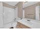 Bright bathroom featuring a tub with white tile surround and a single sink vanity at 104 Hutton Ln, Las Vegas, NV 89145