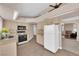 A fully equipped kitchen featuring tile floors, essential appliances, and ample countertop space at 104 Hutton Ln, Las Vegas, NV 89145