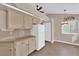 Well-lit kitchen showcasing tan cabinetry, granite countertops, and modern white appliances at 104 Hutton Ln, Las Vegas, NV 89145