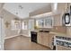 Eat-in kitchen with tile floors, black appliances, and ample sunlight at 104 Hutton Ln, Las Vegas, NV 89145