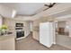 Bright kitchen with stone countertops, modern appliances, tile backsplash, and views to the living room at 104 Hutton Ln, Las Vegas, NV 89145