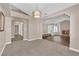 Open-concept living room featuring a fireplace, hardwood floors, plush carpet, and modern lighting fixtures at 104 Hutton Ln, Las Vegas, NV 89145