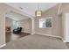 Inviting living room with neutral carpet, fireplace, and ample natural light at 104 Hutton Ln, Las Vegas, NV 89145