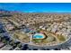 Aerial view of the neighborhood featuring a community pool, park, and mountain views at 10564 Tranquil Glade Ln, Las Vegas, NV 89135