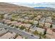 Picturesque aerial view of a residential neighborhood with mountain views in the distance at 10564 Tranquil Glade Ln, Las Vegas, NV 89135