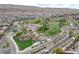 An aerial view showcases the park's recreational facilities, green spaces, and its prime location within a vibrant community at 10564 Tranquil Glade Ln, Las Vegas, NV 89135