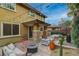 Backyard with a built-in outdoor kitchen, patio seating around a fire pit, and landscape at 10564 Tranquil Glade Ln, Las Vegas, NV 89135