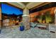 Outdoor kitchen and lounge area with built-in grill and stone-accented columns at 10564 Tranquil Glade Ln, Las Vegas, NV 89135