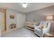 Bedroom with a crib, chair, and neutral color scheme at 10564 Tranquil Glade Ln, Las Vegas, NV 89135