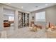 Spacious bonus room with built-in bookshelves, playroom decor, and modern vinyl plank flooring at 10564 Tranquil Glade Ln, Las Vegas, NV 89135