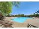 Large community pool with ample deck space, lounge chairs, and umbrellas for shade at 10564 Tranquil Glade Ln, Las Vegas, NV 89135