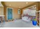 Cozy front porch featuring stone pillars, a swing bench, and a charming wreath on the teal front door at 10564 Tranquil Glade Ln, Las Vegas, NV 89135