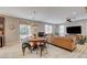 Open concept living and dining area featuring a sliding glass door to the exterior at 10564 Tranquil Glade Ln, Las Vegas, NV 89135