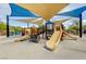 Fun community playground featuring slides, climbing structures, and shaded canopies at 10564 Tranquil Glade Ln, Las Vegas, NV 89135