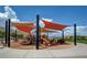 A large playground features multiple slides and play equipment under shade, perfect for active in the community at 10564 Tranquil Glade Ln, Las Vegas, NV 89135