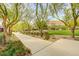 Charming street view with mature trees, well-kept lawns, and beautifully landscaped front yards at 10564 Tranquil Glade Ln, Las Vegas, NV 89135