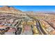 Wide aerial shot of a sprawling neighborhood, highlighting the uniformity of the homes and surrounding mountains at 144 Sarabeth St, Las Vegas, NV 89138