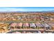 Expansive aerial view showcasing a well-planned community with numerous homes and a cityscape backdrop at 144 Sarabeth St, Las Vegas, NV 89138