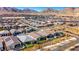 High-angle aerial view of a residential neighborhood, showcasing a mix of homes, desert scenery, and mountain views at 144 Sarabeth St, Las Vegas, NV 89138