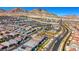 Sweeping aerial view displaying a residential area set against a picturesque mountain range and desert landscape at 144 Sarabeth St, Las Vegas, NV 89138