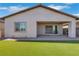 Back exterior featuring a covered patio and lush green lawn at 144 Sarabeth St, Las Vegas, NV 89138