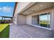 Relaxing covered back patio featuring a ceiling fan and access to the landscaped backyard at 144 Sarabeth St, Las Vegas, NV 89138