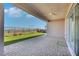 View of covered back patio with ceiling fan and low-maintenance landscaping at 144 Sarabeth St, Las Vegas, NV 89138