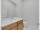 Half bathroom features a wood vanity, a white countertop and modern fixtures at 144 Sarabeth St, Las Vegas, NV 89138