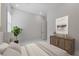 Stylish bedroom featuring wood dresser, shuttered windows and plant at 144 Sarabeth St, Las Vegas, NV 89138