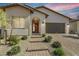 Inviting front entrance featuring brick pathway, desert landscaping and an arched doorway at 144 Sarabeth St, Las Vegas, NV 89138