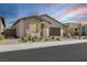 Charming single-story stucco home with an arched entry, desert landscaping, and a two-car garage at 144 Sarabeth St, Las Vegas, NV 89138