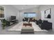 Bright living room with tile floors, modern furniture, and sliding doors to the outdoor area at 144 Sarabeth St, Las Vegas, NV 89138