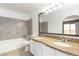 Bathroom featuring double sinks, granite counters, and modern tile in the tub and shower at 1844 N Decatur Blvd # 203, Las Vegas, NV 89108