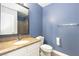 Bathroom featuring granite counters, and modern blue walls with updated fixtures at 1844 N Decatur Blvd # 203, Las Vegas, NV 89108