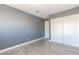 Bedroom with neutral gray walls and wood-look flooring with closet at 1844 N Decatur Blvd # 203, Las Vegas, NV 89108