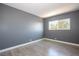 Inviting bedroom featuring gray walls, light-colored flooring, and a bright window at 1844 N Decatur Blvd # 203, Las Vegas, NV 89108