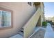 Exterior staircase leading up to a condo with neutral color scheme and desert landscaping at 1844 N Decatur Blvd # 203, Las Vegas, NV 89108