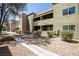 Exterior view of a multi-story condo building and desert landscaping at 1844 N Decatur Blvd # 203, Las Vegas, NV 89108