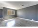 Bright living room featuring gray walls, light-colored flooring, and a window at 1844 N Decatur Blvd # 203, Las Vegas, NV 89108