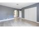 Relaxing main bedroom with gray walls, wood-look floors, and access to the ensuite bathroom at 1844 N Decatur Blvd # 203, Las Vegas, NV 89108