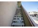 Close up of the exterior staircase leading up to a condo with neutral color scheme at 1844 N Decatur Blvd # 203, Las Vegas, NV 89108