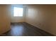 This bedroom has wood floors, a window for light and neutral walls at 19 E Agate Ave # 406, Las Vegas, NV 89123