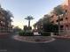 Attractive entrance with a decorative fountain, palm trees, and manicured landscaping creating a welcoming ambiance at 19 E Agate Ave # 406, Las Vegas, NV 89123