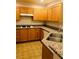 Kitchen features wooden cabinets, white appliances, and granite countertops at 19 E Agate Ave # 406, Las Vegas, NV 89123