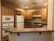 Bright kitchen with granite countertops, wooden cabinets and white appliances at 19 E Agate Ave # 406, Las Vegas, NV 89123