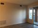 Neutral living area with balcony access and modern laminate flooring at 19 E Agate Ave # 406, Las Vegas, NV 89123