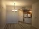 The living room features wood floors, a decorative chandelier, and a view of the kitchen at 19 E Agate Ave # 406, Las Vegas, NV 89123